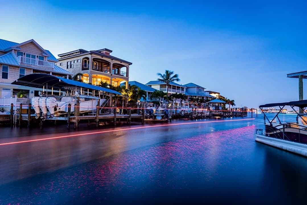 Waterfront homes and boat docks along a Southwest Florida canal at dusk